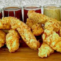 Chicken Tenders · Eight crispy white meat chicken tenders fried to perfection and paired with your favorite sa...