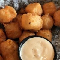 Surly Cheese Curds · Cheddar cheese dredged in our surly beer batter, served with ranch dressing. Vegetarian.
