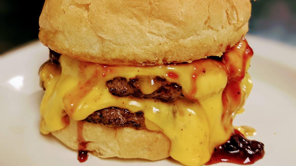 Pb&J Bobert Combo · Two ¼ lb. Bobert burgers topped with two slices of American cheese, grape jelly and creamy peanut butter on a hamburger bun.