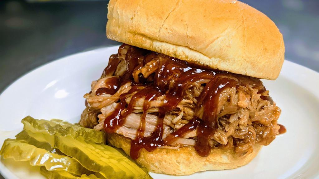 Bbq Pulled Bobert Combo · Specially seasoned, homemade pulled pork topped with our BBQ sauce, piled high on a grilled bun served with pickle slices on the side.