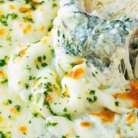 Asiago Spinach Dip · Rich and creamy house made dip with prosciutto and garlic breadsticks.