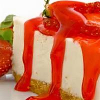 Colossal Strawberry Cheesecake · Rich and creamy cheesecake covered with strawberries.