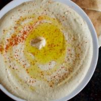 Hummus · A blend of ground chickpeas mixed with tahini, topped with olive oil and spices, and served ...
