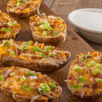 Trail Potatoes · 1210-1650 cal. Crispy halves of skin-on baked potatoes, loaded with a blend of melted cheese...