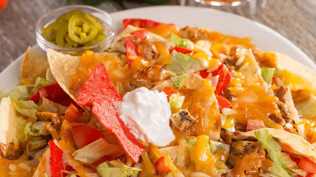 Chipotle Chicken Nachos · 2340 cal. Crispy nacho chips covered in a blend of cheeses, refried beans, chicken, rice, and chipotle sauce. Topped with lettuce, diced tomatoes, and sour cream. Served with jalapeños.
