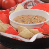 Queso Dip · 900 cal. Cheese dip with seasoned ground beef. Served with tortilla chips.