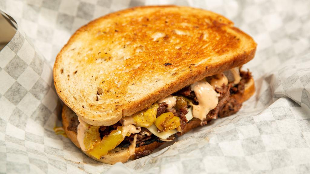 Baba'S Hungry · Grilled rye bread, baba's sauce, spicy mustard, corned beef, pastrami, swiss and pepper jack cheese, jalapenos, onions and banana peppers.