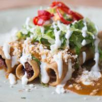 Flautas De Res · Three fried tortillas filled with shredded beef, served with a tres chiles salsa, lettuce, c...