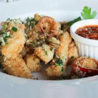 Fried Calamari · Spicy Peppers, Romano Cheese, Roasted Tomato Sauce.