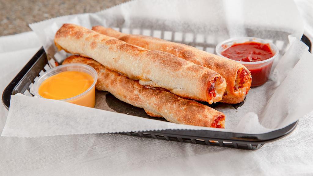 Pepperoni Sticks · Three fresh-baked breadsticks stuffed with pepperoni and cheese served with a choice of red sauce, cheddar cheese, nacho cheese, or garlic butter.