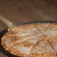 Dessert Pizza · Our homemade dough backed up soft, covered with cinnamon, sugar and topped with vanilla icing.