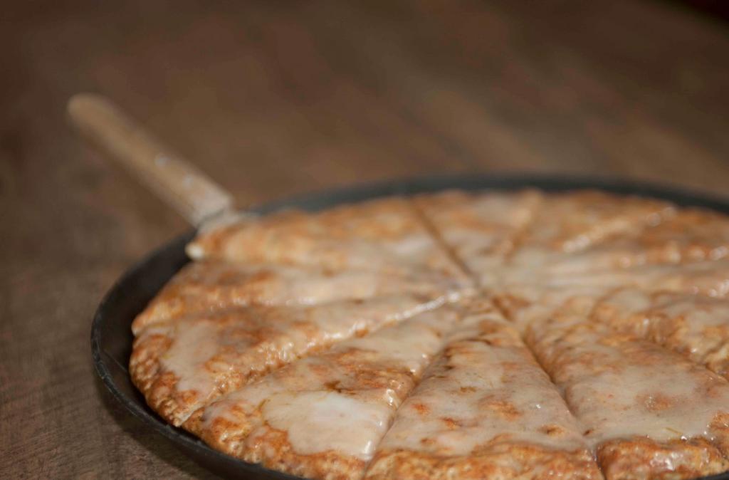 Dessert Pizza · Our homemade dough backed up soft, covered with cinnamon, sugar and topped with vanilla icing.