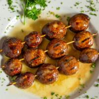 Grilled Mushrooms Appetizer · Juicy mushrooms grilled to perfection and served in a garlic butter sauce.