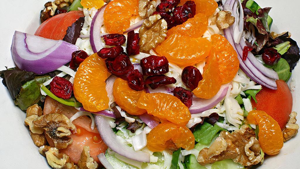 Michigan Salad · Spring mix, dry cherries, Mandarin oranges, walnuts, tomatoes, cucumber slices, onions, mozzarella cheese, and raspberry vinaigrette dressing.