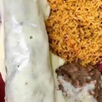 Burrito Texano · Our famous big burrito filled with steak, chicken and shrimp cooked with onions, tomatoes an...
