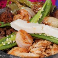 Molcajete · Our tender steak, grilled chicken, shrimp, pork and chorizo served on a Mexican stone garnis...