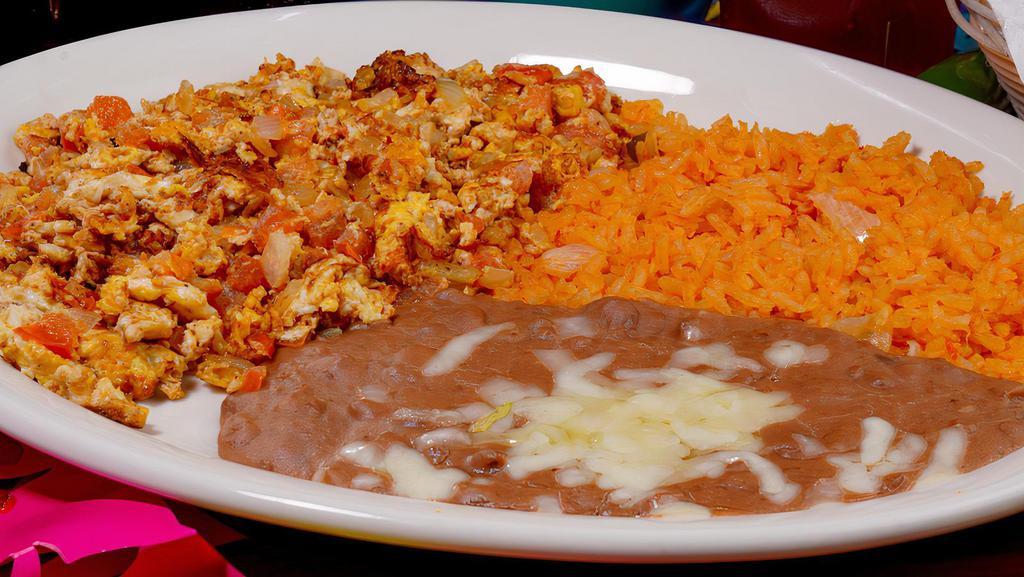 Huevos Mexicanos · Scrambled eggs with tomato, onions and peppers, served with rice and beans.