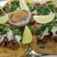 Tacos De Carne Asada · Street tacos. Our famous three steak tacos topped with cilantro and onions and our delicious...