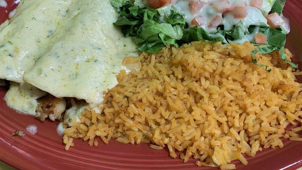 Enchiladas Del Mar · Two grilled shrimp enchiladas with mushrooms on a flour tortillas covered on our special cilantro cream sauce garnished with rice and ceasar salad.