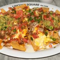 Breakfast Nachos · Homemade chips, topped with black beans, Tyner pond farms chorizo, spicy queso, pico de gall...