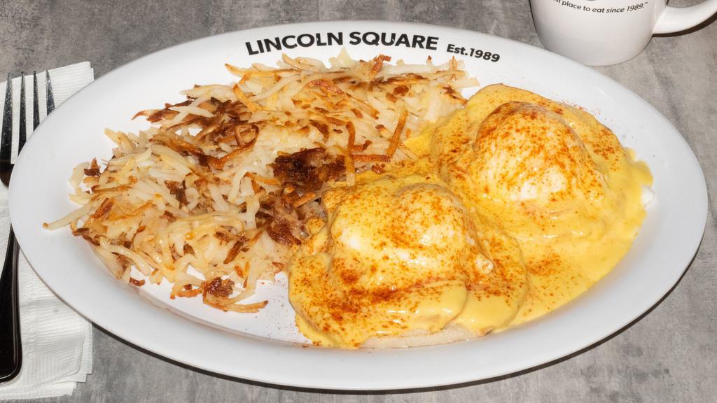 Eggs Benedict · Split English muffin topped with Canadian bacon and two poached eggs, rich hollandaise sauce, sprinkled with paprika & served with hash browns.