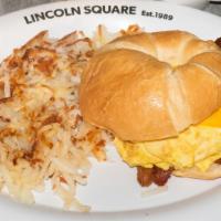 Breakfast Croissant · Two scrambled eggs on a grilled croissant finished with melted cheese, served with hash brow...
