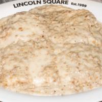 Biscuits & Gravy · Hot out-of-the-oven half order, biscuit split and topped with rich homemade sausage gravy.