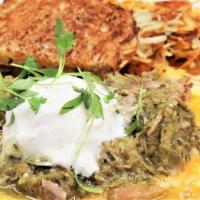 Southern Omelet · Slow roasted pork, jalapeno, and onion, smothered in pork green chili. Topped with cheddar-j...