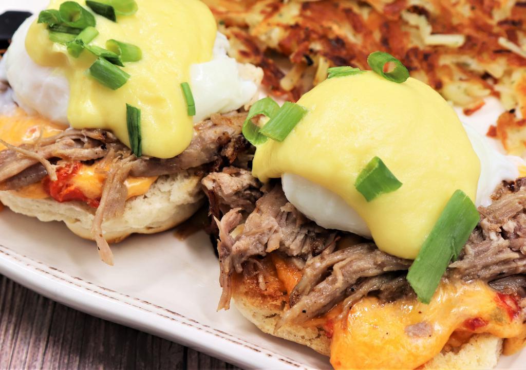 Southern Benedict · Toasted biscuit, pimento cheese, pulled pork and poached eggs. Topped with crafted hollandaise and green onion.