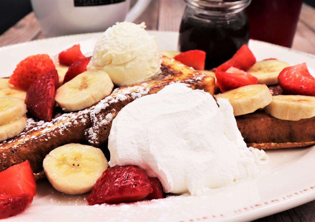 Strawberry & Banana French Toast · Thick-cut brioche, battered and griddled to perfection. Topped with banana and strawberries.