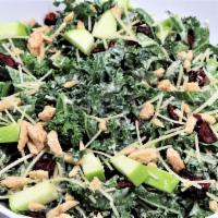 Kale Caesar · Dried cranberries, apples, parmesan cheese, candied almonds, and pesto Caesar dressing.