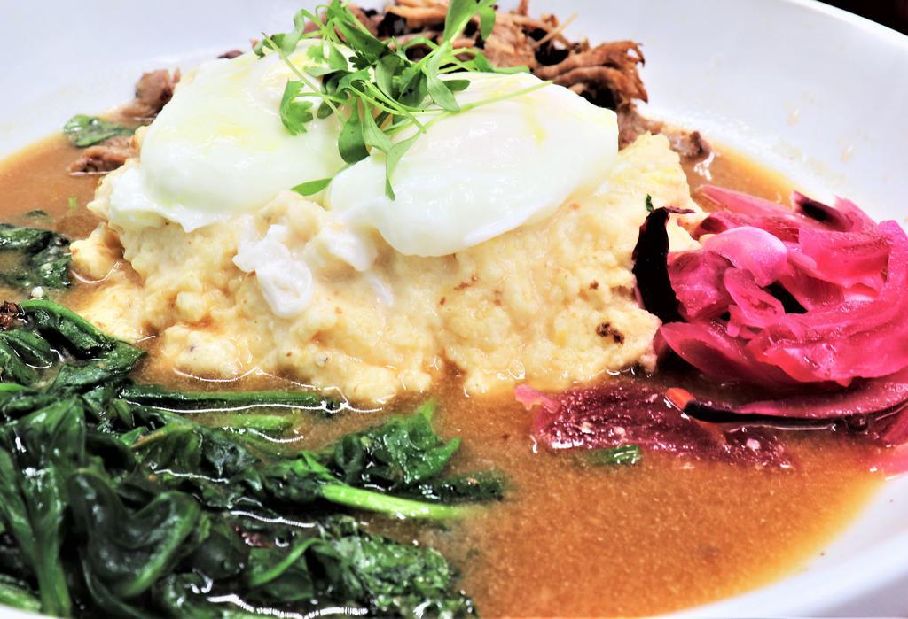 Southern Bowl · Creamy cheddar grits, pulled pork, Carolina Jus, sauteed spinach, pickled red onion, poached eggs, and micro cilantro.