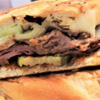 Cubano · Mojo sauce, sliced ham, slow roasted pork, swiss cheese, and pickles on a toasted hoagie roll.