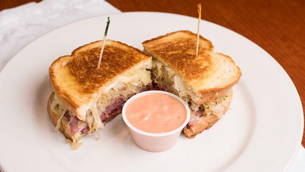 Corned Beef Reuben · Served with homemade sauerkraut and swiss on grilled rye. Thousand Island on the side.