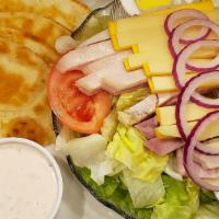 Julienne Salad · Fresh crisp lettuce with strips of oven roasted turkey, ham, american and swiss cheese, toma...