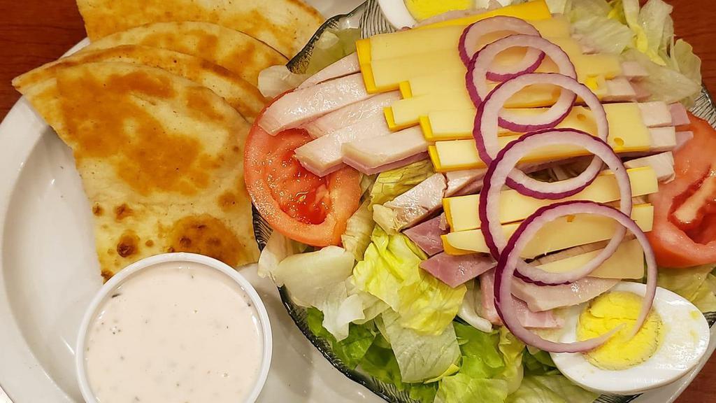 Julienne Salad · Fresh crisp lettuce with strips of oven roasted turkey, ham, american and swiss cheese, tomato, onion, hard boiled egg and pita bread.