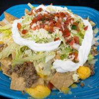 Lunch Nachos Supremo · Nachos with shredded chicken or ground beef, topped with cheese dip, lettuce, sour cream, pi...