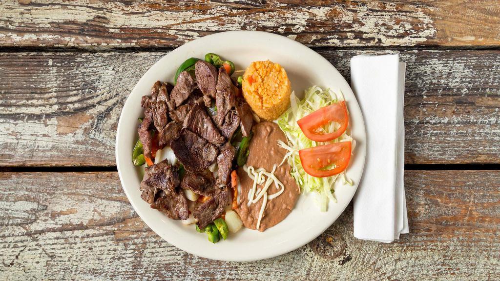 Bistec A La Mexicana · Chopped ribeye steak sauteed with tomatoes onions and jalapenos served with rice and beans.