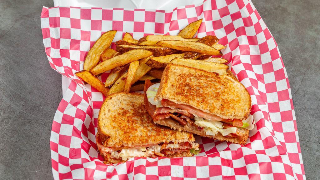 Loaded Blt With Cream Cheese Spread · BLT with a twist.  Cream Cheese spread with Bacon and green onions melted on toast then topped with bacon lettuce and tomatoa for a mouth watering bite.  Served with fries or specialty side of the day.