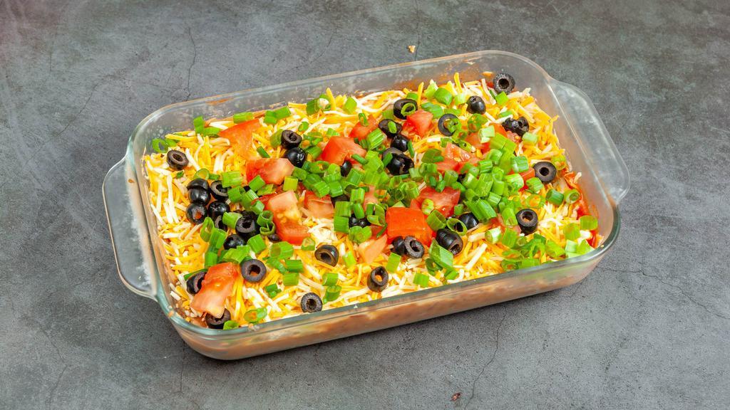 7 Layer Dip (Half Pan)  · Refried beans, sour cream, taco sauce, shredded cheese, diced tomatoes, black olives, and green onions layered into a mouth watering old school dip combo.