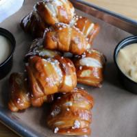 Pretzel Bites · A boatload of warm and buttery pretzel bites tossed in kosher salt with beer cheese and must...