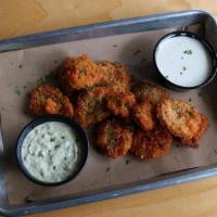 Fried Pickle Chips · Insanely crunchy fried pickles served with ranch and house-made poblano remounted dipping sa...