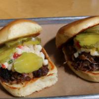 Pulled Pork Sliders · Slow-cooked in our special house ginger miso sauce, topped with pickles and house-made apple...