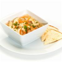 Greek Lemon Chicken Soup · Bowl of our fresh homemade Lemon Chicken Soup served with Soft Pita.