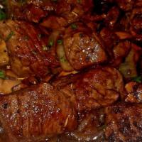 Sirloin Steak Bites · Sirloin steak bites served on a bed of  saute mushrooms and onions and drizzled with balsami...