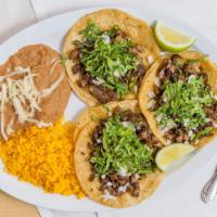 Taco Dinner · 3 Tacos with the meat or vegetarian filling of your choice, served with rice & beans.