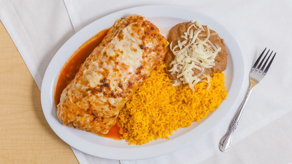 Burrito Suizo Dinner · Contains beans, lettuce, tomato, onions, cheese, sour cream topped with ranchera sauce and melted cheese. Served with a side of rice and beans.