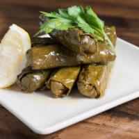 Dolmades · Six Stuffed Grape Leaves with Rice and Fresh Herbs. Served Chilled