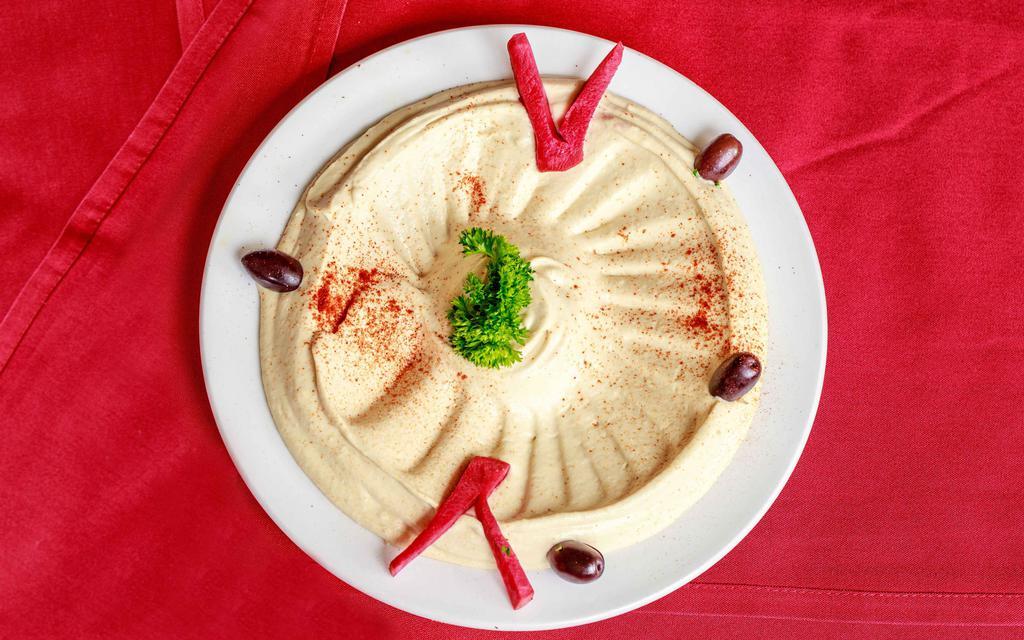 Hummus · Denotes vegetarian selections. Chickpeas puréed with tahini sauce, lemon juice and a hint of fresh garlic. Add a little olive oil and enjoy.