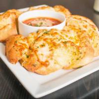 Garlic Bread · Fresh Italian bread topped with garlic butter, Romano cheese. Served with marinara dipping s...